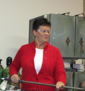 Julie at Atlantic Art Glass in Ellsworth learning how to blow a glass ball