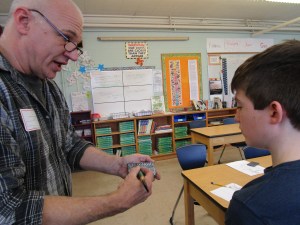 Teaching Artist Tim Christensen works with a student at Camden-Rockport Middle School